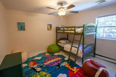 a room with two bunk beds and a ceiling at Huge Pocono Dreamhouse 4 bedrooms 12 guests in Blakeslee