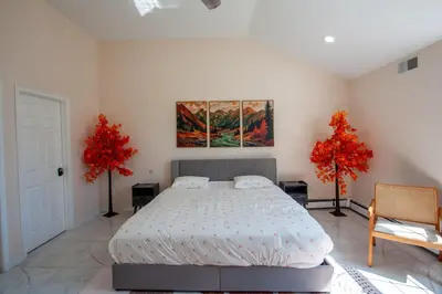 a bedroom with a bed and a painting on the wall at Huge Pocono Dreamhouse 4 bedrooms 12 guests in Blakeslee