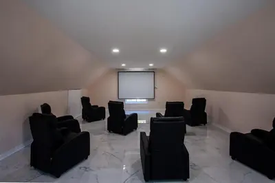 a large room with chairs and a projection screen at Huge Pocono Dreamhouse 4 bedrooms 12 guests in Blakeslee
