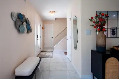 a hallway with a bench and a vase with flowers at Huge Pocono Dreamhouse 4 bedrooms 12 guests in Blakeslee