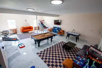 a living room with a ping pong table in it at Huge Pocono Dreamhouse 4 bedrooms 12 guests in Blakeslee