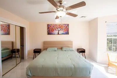 a bedroom with a bed and a ceiling fan at Huge Pocono Dreamhouse 4 bedrooms 12 guests in Blakeslee