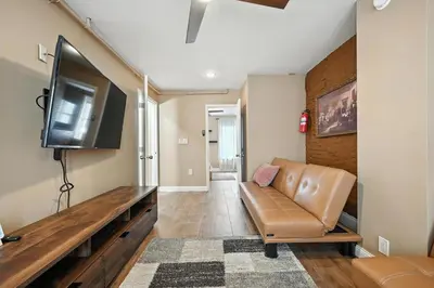 a living room with a couch and a flat screen tv at Spacious Family Home in Philadelphia in Philadelphia