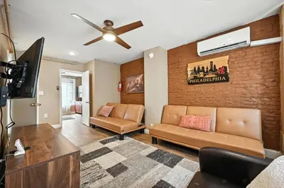 a living room with a couch and a ceiling fan at Spacious Family Home in Philadelphia in Philadelphia