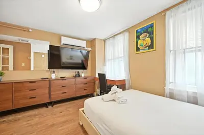 a bedroom with a bed and a flat screen tv at Spacious Family Home in Philadelphia in Philadelphia