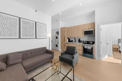 a living room with a couch and a chair at 19-4G 2BR 2Baths Luxury Apt East Village in New York