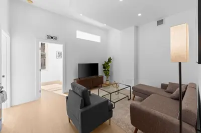a living room with a couch and a tv at 19-4G 2BR 2Baths Luxury Apt East Village in New York