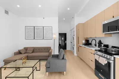 a kitchen and living room with a couch and a table at 19-5D 2BR 2Baths Luxury Apt East Village in New York