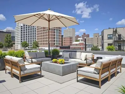 a patio with couches and a table and an umbrella at 19-5D 2BR 2Baths Luxury Apt East Village in New York