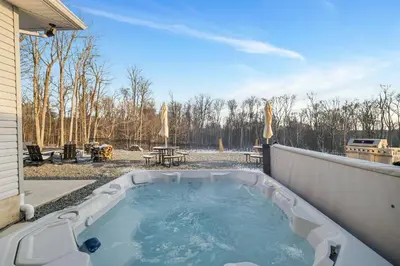 a hot tub on the back of a backyard at The Perfect Pocono Escape in Pocono Farms East