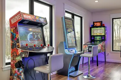 a room with two arcade games and a pinball machine at The Perfect Pocono Escape in Pocono Farms East