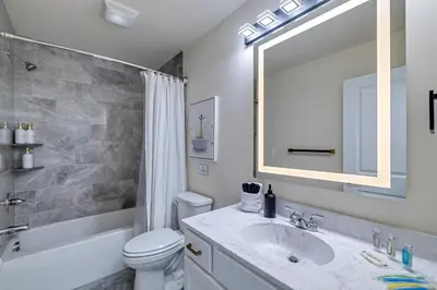 a bathroom with a sink and a toilet and a mirror at The Perfect Pocono Escape in Pocono Farms East