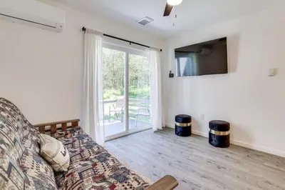 a living room with a couch and a television at Hot Tub and Game Room Wooded Poconos Retreat in Tobyhanna