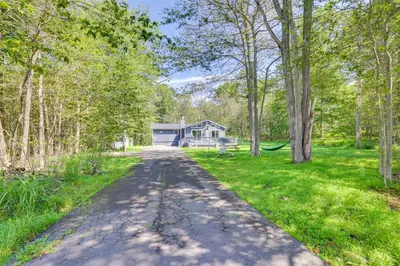 a road leading to a house in the woods at Hot Tub and Game Room Wooded Poconos Retreat in Tobyhanna