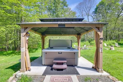 a barbecue under a gazebo in a park at Hot Tub and Game Room Wooded Poconos Retreat in Tobyhanna