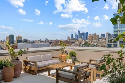 a patio with a table and chairs on a roof at Freeman 602 by Rove Travel - Condo with Shared Amenities in New York