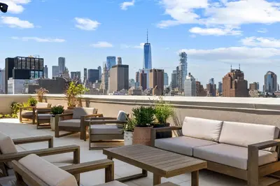 a rooftop patio with couches and a view of the city at Freeman 602 by Rove Travel - Condo with Shared Amenities in New York