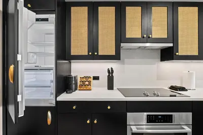 a kitchen with black cabinets and a sink at Freeman II by Rove 1BR Condo with Shared Amenities in New York