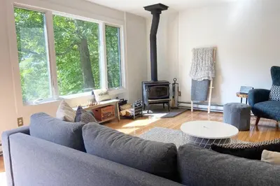 a living room with a couch and a fireplace at Fireplace Catskill Views Overlook Lake Cabin in Parksville