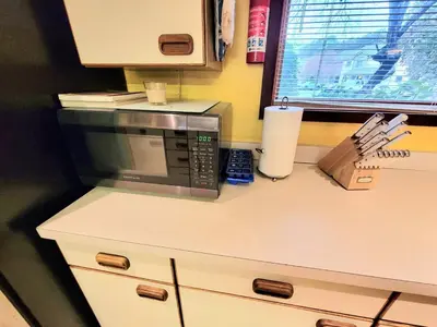 a kitchen counter with a microwave and a window at Shawnee Ski Mountain View Jacuzzi Townhouse in East Stroudsburg
