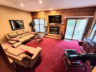 a large living room with a couch and a television at Shawnee Ski Mountain View Jacuzzi Townhouse in East Stroudsburg