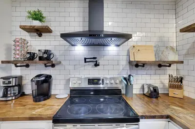 a kitchen with a stove top oven in a kitchen at Winter retreat, hot tub, game room, indoor pool, in Long Pond