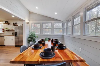 a dining room with a wooden table and chairs at Winter retreat, hot tub, game room, indoor pool, in Long Pond