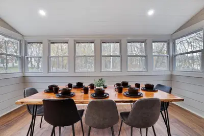 a dining room with a wooden table and chairs at Winter retreat, hot tub, game room, indoor pool, in Long Pond