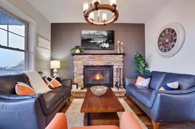 a living room with couches and a fireplace at Mountain Chalet Ski, Hike, & Explore in Tannersville