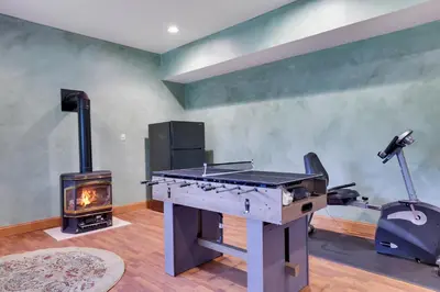 a living room with a grill and a wood stove at Harmony Haven Large Deck Hot Tub Ski in Split Rock
