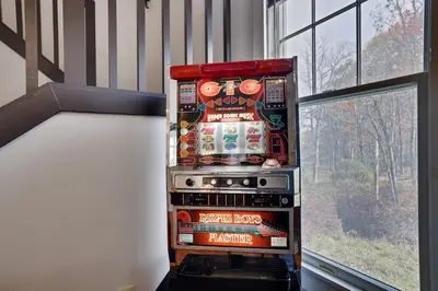 a pinball machine in a room next to a window at Spruce Ridge Lodge Ski, Hike & Relax in Tannersville