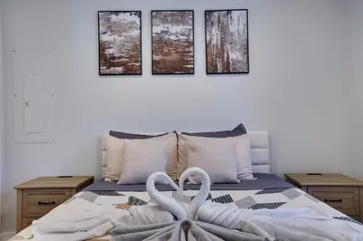 two white swans are sitting on a bed at Spruce Ridge Lodge Ski, Hike & Relax in Tannersville