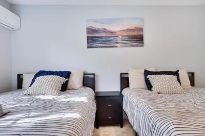 a bedroom with two beds and a painting on the wall at Spruce Ridge Lodge Ski, Hike & Relax in Tannersville