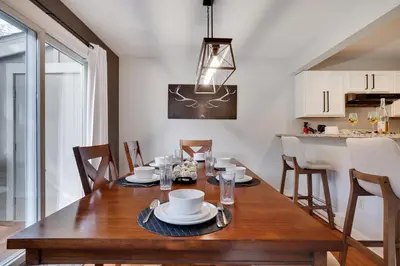 a dining room with a wooden table with chairs at Spruce Ridge Lodge Ski, Hike & Relax in Tannersville