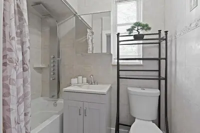 a bathroom with a toilet and a sink and a shower at 20 min to NYC, Newly Renovated, Private Driveway in Little Ferry
