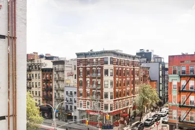 a view of a busy city street with buildings at Blueground Alphabet City view nr Tompkins Square Park NYC-1978 in New York