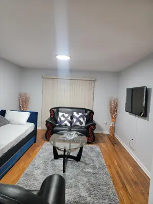 a living room with a couch and a tv at Urban Nest in Newark