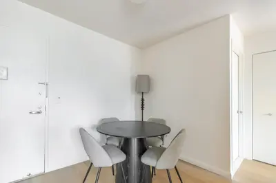 a dining room with a table and chairs at Blueground Upper West Side fitness nr Central Park NYC-1994 in New York
