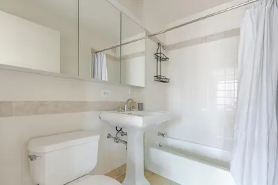 a white bathroom with a sink and a toilet at Blueground Upper West Side fitness nr Central Park NYC-1994 in New York