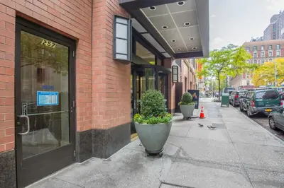 a building with a door on the side of a street at Blueground Upper West Side fitness nr Central Park NYC-1994 in New York