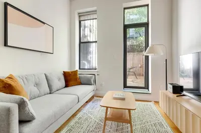 a living room with a couch and a table at Blueground Hells Kitchen terrace nr Times Square NYC-2063 in New York