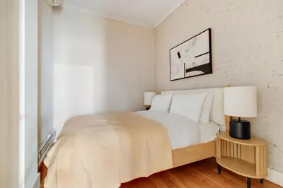 a white bedroom with a bed and a lamp at Blueground Hells Kitchen terrace nr Times Square NYC-2063 in New York