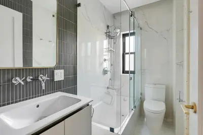 a white bathroom with a sink and a toilet at Blueground Brooklyn Heights view nr Brooklyn Bridge NYC-1987 in Brooklyn