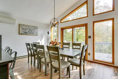 a dining room with a table and chairs at Luxury Home with Game Room, 4 Mi to Bushkill Falls! in Saw Creek
