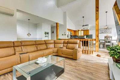 a living room with a couch and a glass table at Luxury Home with Game Room, 4 Mi to Bushkill Falls! in Saw Creek