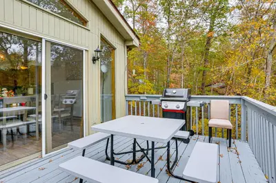 a patio with a grill and a table and chairs at Luxury Home with Game Room, 4 Mi to Bushkill Falls! in Saw Creek