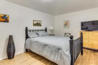 a bedroom with a bed and a flat screen tv at Easy NYC Commute Guttenberg Getaway Near Parks in Guttenberg
