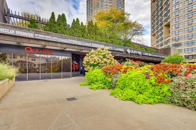 a flower garden in front of a store at Easy NYC Commute Guttenberg Getaway Near Parks in Guttenberg