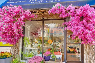a flower shop with pink flowers in front of it at Easy NYC Commute Guttenberg Getaway Near Parks in Guttenberg