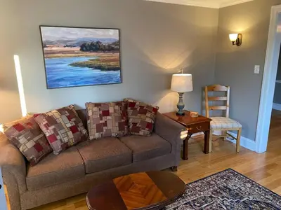a living room with a couch and a table at Bryn Mawr Spacious Grnd Floor Apt Free Parking in Bryn Mawr